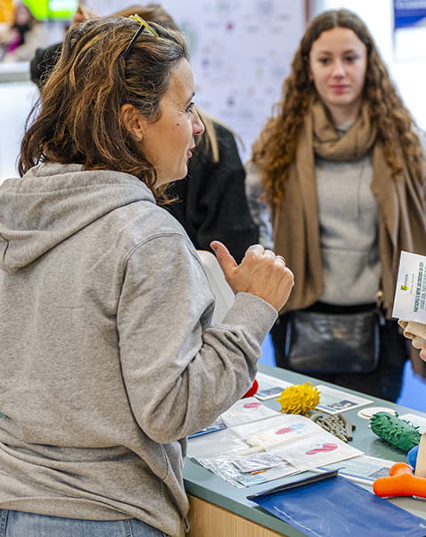 Professionnels donnant des flyers à son stand