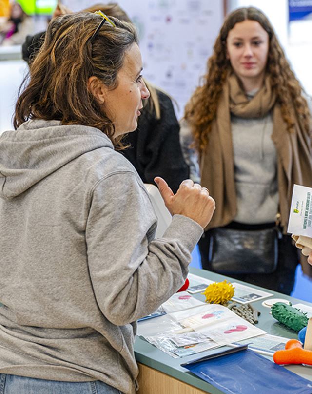 Professionals giving away flyers on their stands